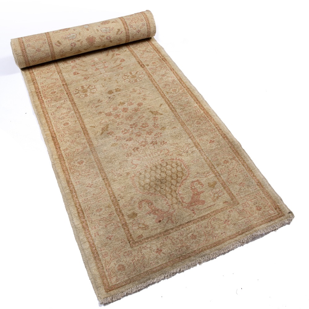A ZIEGLER PALE GREEN GROUND RUNNER with a pastel flower ornament within a wide border, 391cm x 88cm