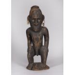 A PAPUA NEW GUINEA, Sepik carved wood male figure, decorated with shell eyes and earrings, 55cm