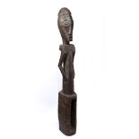 A PRE-BEMBE (BOYO) MALE FIGURE, Democratic Republic of the Congo, carved wood, base with hollow