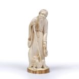 A JAPANESE CARVED IVORY FIGURE of an old man with staff and monkey, signed on base, 19cm high