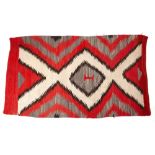 A NATIVE AMERICAN NAVAJO TRIBE CORAL GROUND BLANKET with a hooked cross and diamond central