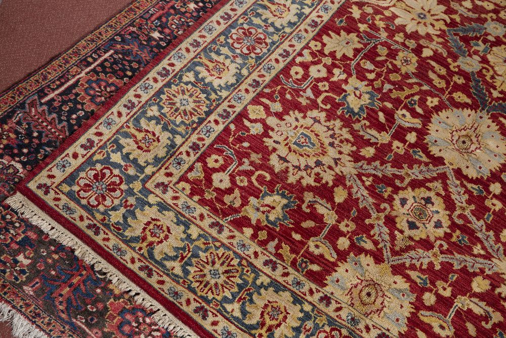 AN AGRA RED GROUND CARPET the repeating foliate and scroll motif within a dark blue ground border, - Image 2 of 5