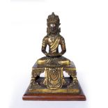 A CHINESE GILT BRONZE BHUDDA, Qing Dynasty, on wooden base, 19.5cm high.