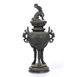 A LATE 19TH CENTURY JAPANESE BRONZE URN AND COVER, surmounted by a seated temple lion, the main body