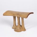 A EAST AFRICAN CARVED WOOD HEADREST, possibly Kenyan with three supporting pillars 16.5cm high