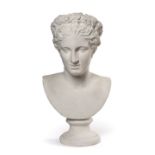 AFTER THE ANTIQUE A PLASTER BUST OF 'FLORA', depicted facing forward with a garland of flowers in