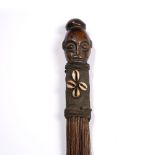 A LUBA HEMBA FLYWHISK, the top carved wood of a male head to a harden cloth decorated by a star made