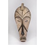 A FANG MASK, Gabon, carved wood with incised line marks with black and white pigments, 74cm high