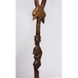 AN AFRICAN WALKING STAFF, Songye style, carved wood, top part has a janiform bird to a female