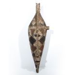 A WEST AFRICAN BOBO MASK, carved wood elongated form with traces of polychrome decoration 85cm high