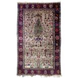 AN ANTIQUE PERSIAN, PERHAPS FERAGHAN SILK RUG decorated with a central apple green ground pine