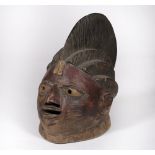 A YORUBA HELMET MASK, Nigeria, carved wood with tall coiffure and scarifications to face, 35cm high