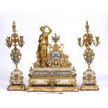 A 19TH CENTURY FRENCH CLOCK GARNITURE DE CHEMINÉE the ornate gilt metal case with porcelain Roman