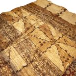 A LARGE OLD TONGAN TAPA CLOTH decorated with geometric and foliate patterns on squares on a light