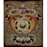 A 19TH CENTURY FRAMED TIBETAN CEREMONIAL BADGE, silk brocade (this could have of possibly