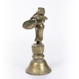 A 19TH CENTURY SOUTH INDIAN BRASS OIL LAMP, figure of lakshmi depicted holding a dish, 24cm high