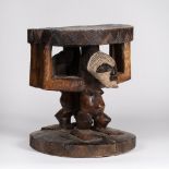 A SONGYE STOOL, Democratic Republic of the Congo, carved wood, Janiform, face decorated with white