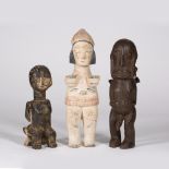 A GROUP OF THREE AFRICAN CARVED WOODEN FIGURES one painted all white a another fertility idol,