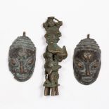 TWO AFRICAN BENIN STYLE SMALL BRONZE MASKS, together with a ashanti gold weight model as a elder