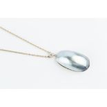 A MABE PEARL AND DIAMOND PENDANT, the oval mabe pearl surmounted by an old-cut diamond in four