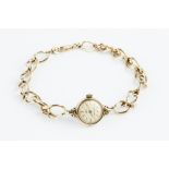 A LADY'S 9CT GOLD BRACELET WATCH, the circular silvered dial with baton markers, signed Ernest Borel
