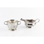 A SILVER TWIN HANDLED CUP, with slightly flared rim, on shaped circular foot, by Wakeley &
