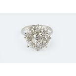 A DIAMOND FLOWERHEAD CLUSTER RING, set throughout with graduated old brilliant-cut diamonds in
