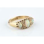 AN OPAL AND DIAMOND HALF HOOP RING, set with a trio of oval cabochon opals, spaced by pairs of