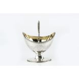 A GEORGE III SILVER SWING HANDLED SUGAR BASKET with beaded borders, engraved with swags of