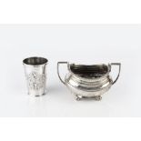 A LATE VICTORIAN SILVER BEAKER with reeded borders, embossed with a cartouche of scrolling