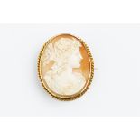 A VICTORIAN SHELL CAMEO BROOCH, the oval shell cameo carved to depict the classical portrait profile