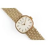 A LADY'S 9CT GOLD BRACELET WATCH BY TISSOT, the cushion-shaped dial with baton markers, to a