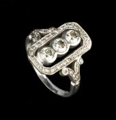 A DIAMOND PANEL RING, the openwork octagonal panel centred with a trio of round brilliant-cut
