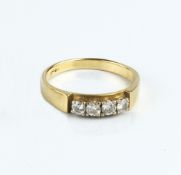 A DIAMOND FOUR STONE RING, the round brilliant-cut diamonds in four claw settings, to a tapered