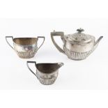 A LATE VICTORIAN SILVER TEAPOT, of oval half lobed form, with ebonised handle and knop, by Thomas