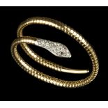 A DIAMOND SET SERPENT BRACELET, modelled as a coiled snake, his head pavé set with rose-cut diamonds