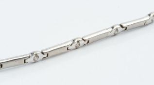A DIAMOND SET BRACELET, designed as a line of baton-shaped panels of brushed finish, spaced by round