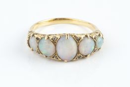 AN OPAL FIVE STONE RING, the oval and circular cabochon opals spaced by rose-cut diamonds points,
