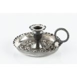 AN EARLY VICTORIAN SILVER SMALL CHAMBERSTICK, with tall, flared body, leaf capped scroll handle,