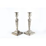 A MATCHED PAIR OF SILVER CANDLESTICKS, of Neo-classical design, the tapered square section columns