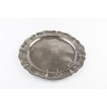 A WHITE METAL CIRCULAR PLATTER, with shaped border and spot hammered decoration, stamped 900, 35cm