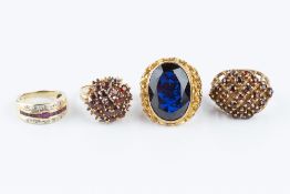 A COLLECTION OF DRESS RINGS, comprising a ruby and diamond half hoop ring, stamped '750', a blue