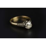 A DIAMOND SINGLE STONE RING, the cushion-shaped old-cut diamond in eight claw setting, between