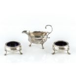 A GEORGE III SILVER SAUCEBOAT with scroll handle on pad feet, by David & Robert Hennell, London