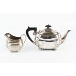 A SILVER TEAPOT, of shaped outline and with ebonised handle and knop, on bun feet, Chester 1931,