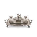 AN EDWARDIAN SILVER INKSTAND, of twin handled shaped rectangular form, fitted with a pair of faceted