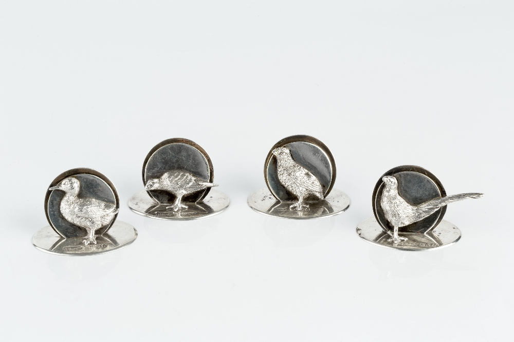 A SET OF FOUR SILVER NOVELTY MENU HOLDERS each modelled with a different game bird, on oval base, by