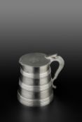 A GEORGE III SILVER TANKARD, the tapered body with bands of reeded decoration, the hinged top with