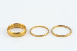 TWO 22CT GOLD WEDDING BANDS, and an 18ct gold wedding band (3)