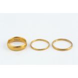 TWO 22CT GOLD WEDDING BANDS, and an 18ct gold wedding band (3)